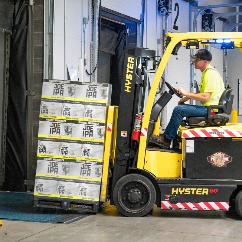 Forklift lifting pallets