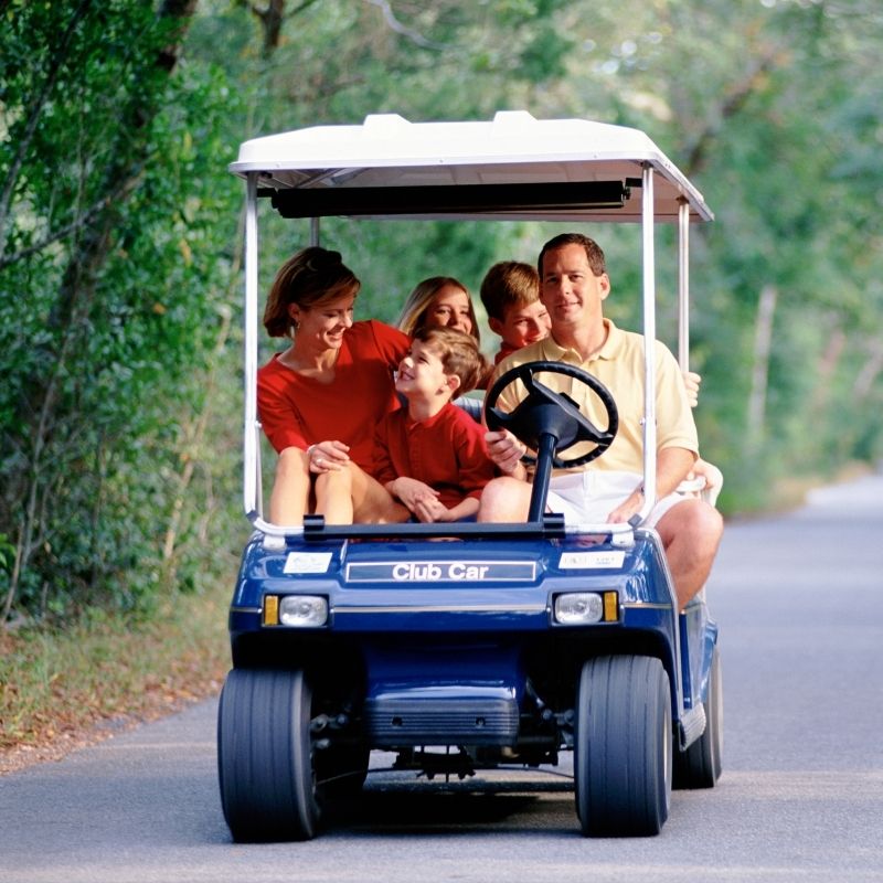 Family on golf cart