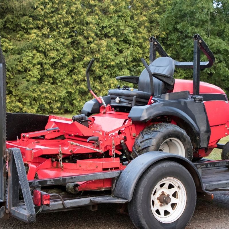 Riding lawn mower on trailer