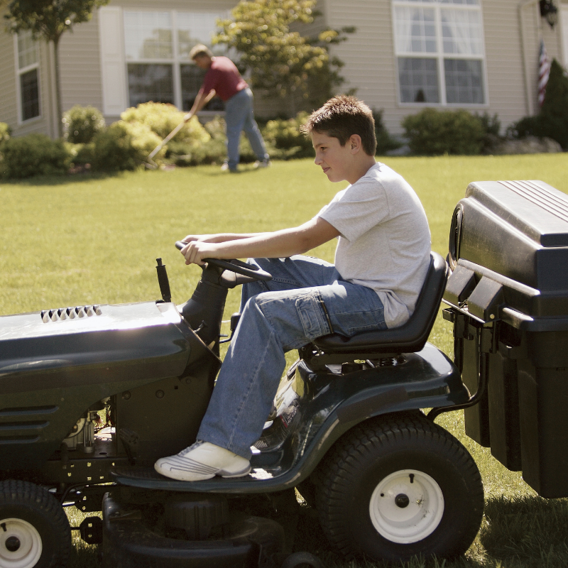 Teenager mowing lawn